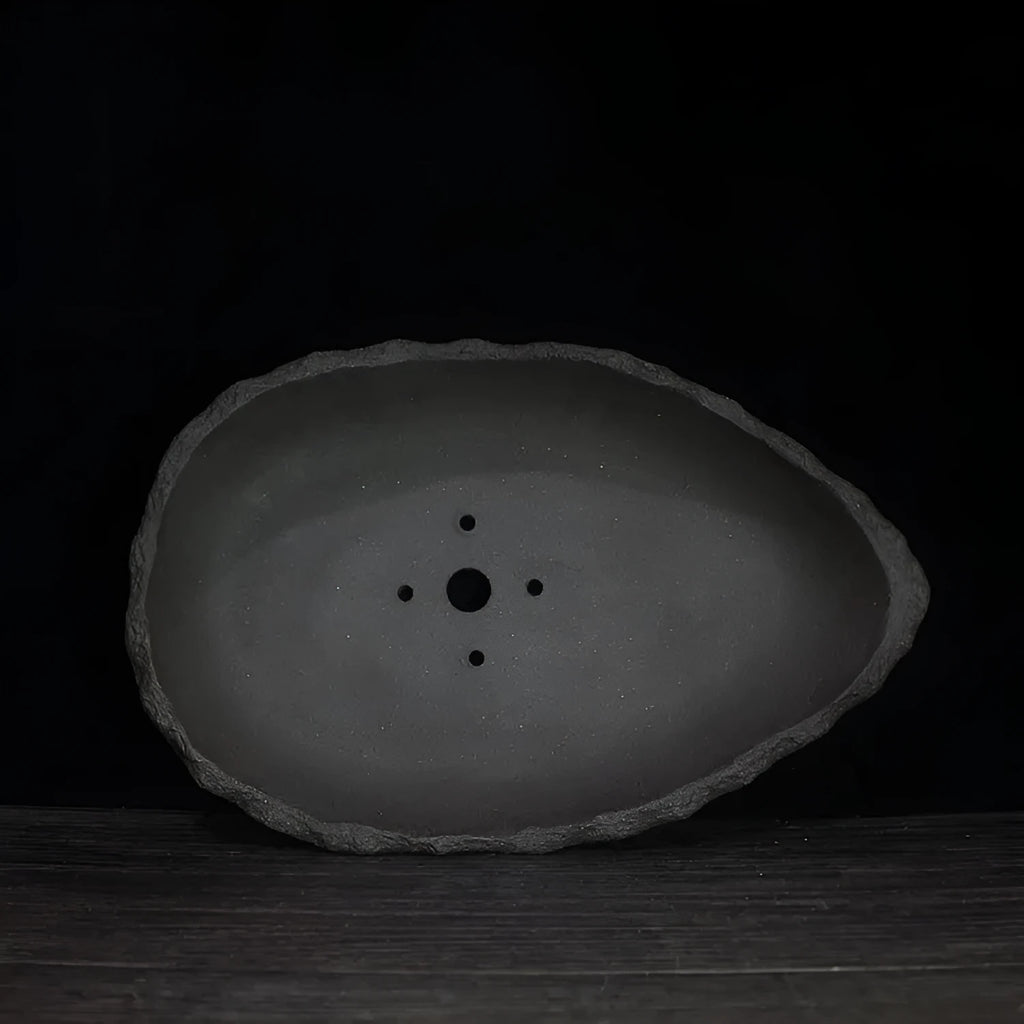 Handmade purple clay flower pot with traditional ceramic finish and drainage hole