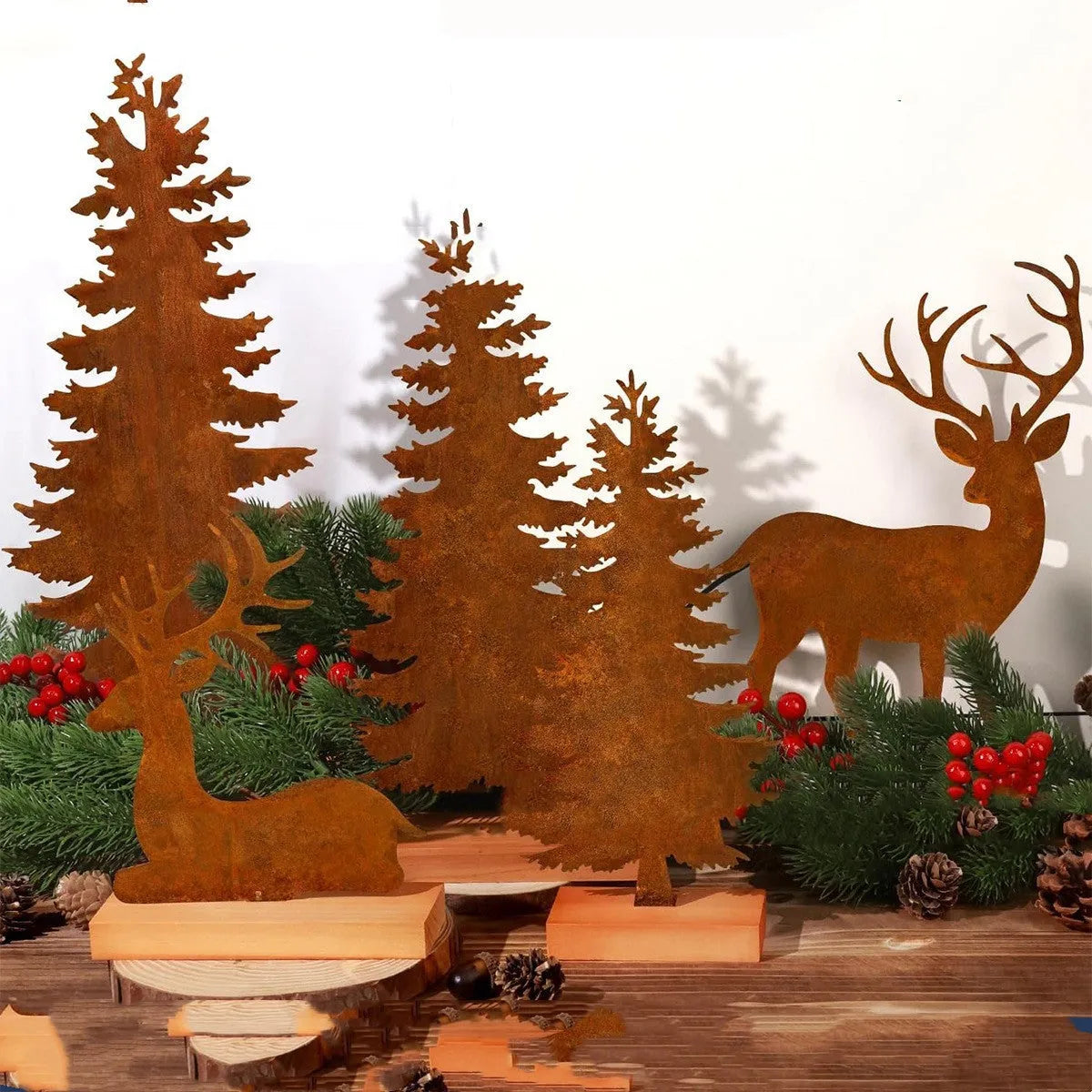 Three metal Christmas tree ornaments with elk silhouettes and rustic rust-effect finish