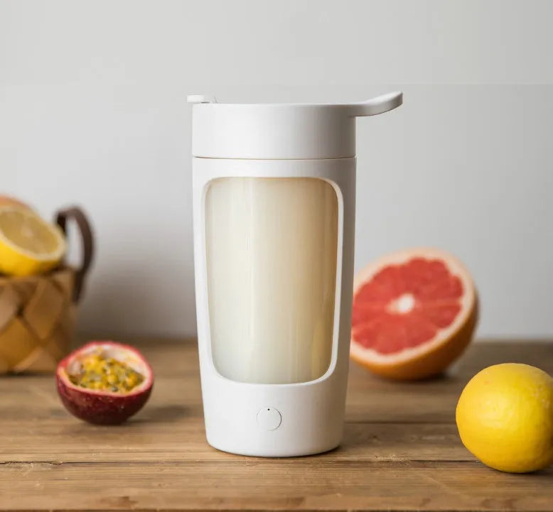 Portable automatic mixing blender cup in black, blue, pink, or white, showing compact size
