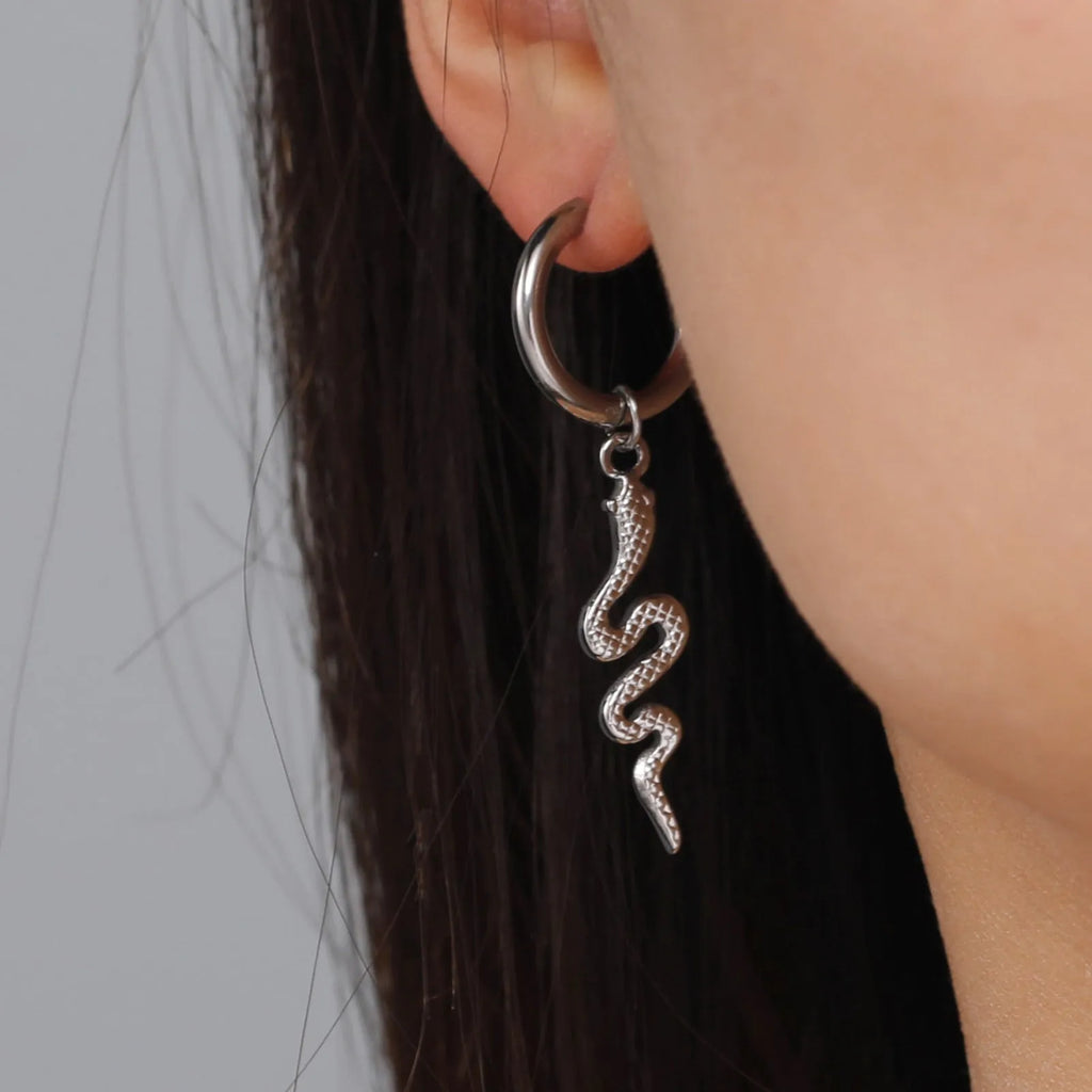 A pair of vintage-style snake-shaped earrings made from gold plated stainless steel with an ear clip fastening.
