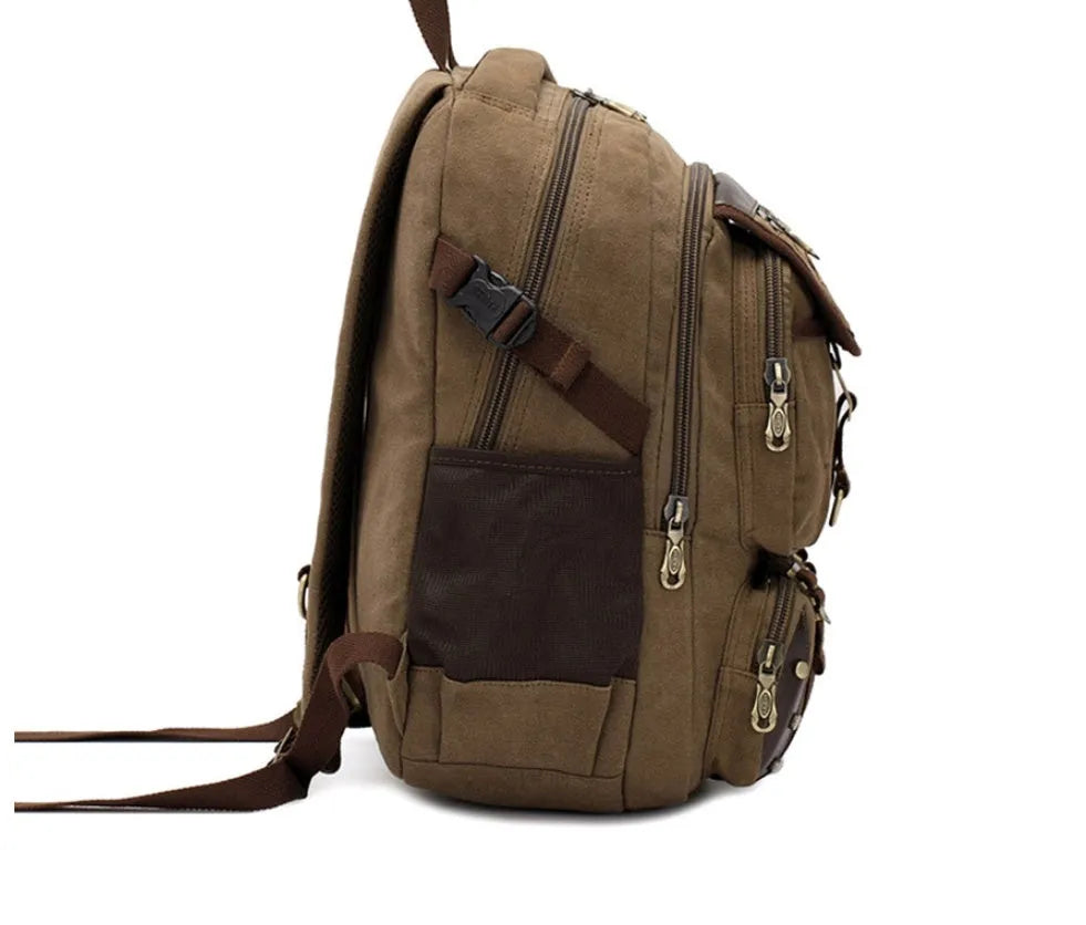 Large canvas computer backpack in military green with car stitching and top handle
