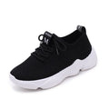 Women's white thick-soled casual sports shoes with woven upper and front strap closure.