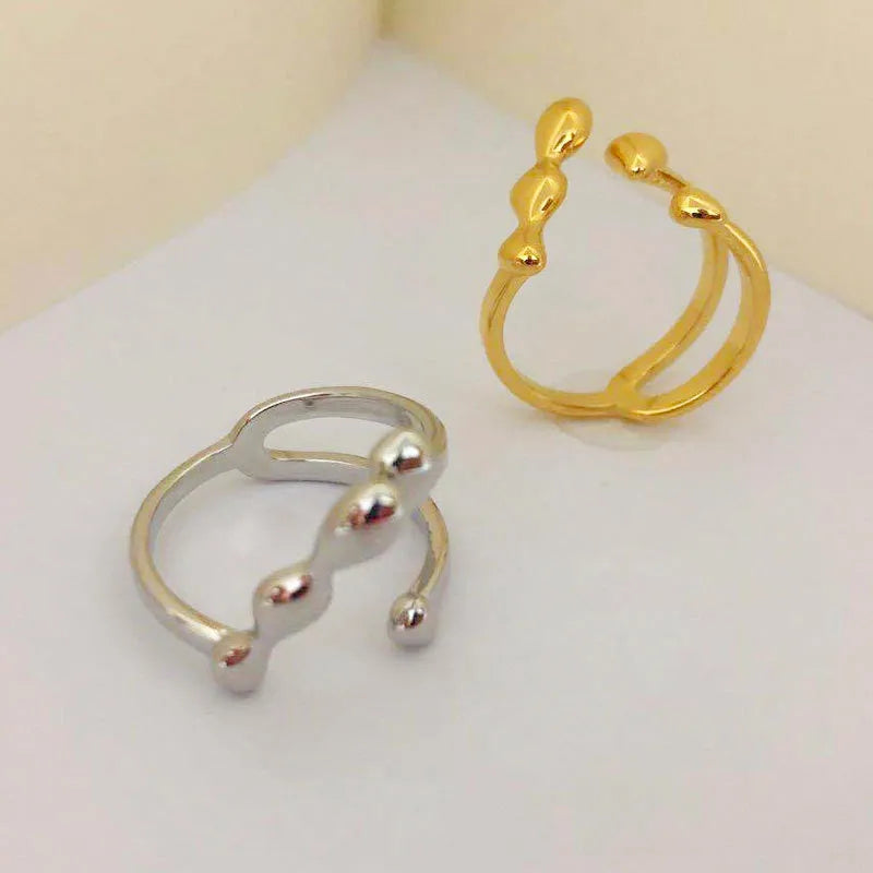 Adjustable opening brass fashion ring with circular sphere decoration in gold or silver finish