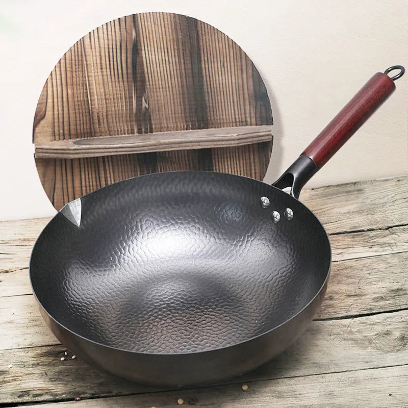 Traditional black iron wok with wooden handle measuring 32cm cooking surface diameter
