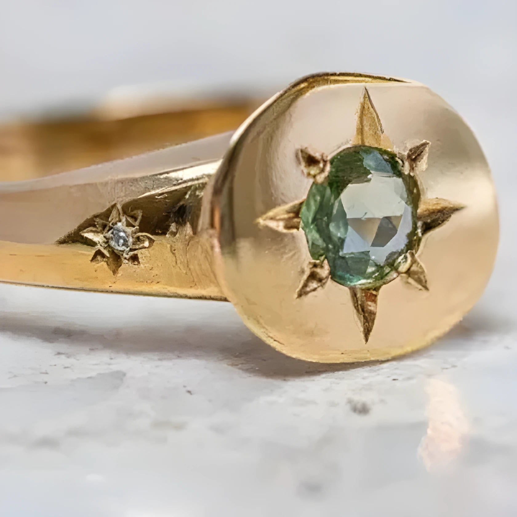 Gold-colour adjustable ring with a star-shaped design and oval asterism zircon.