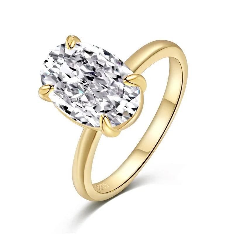 Oval women's ring with a four-claw setting on a silver band, showing gold and silver finish options.