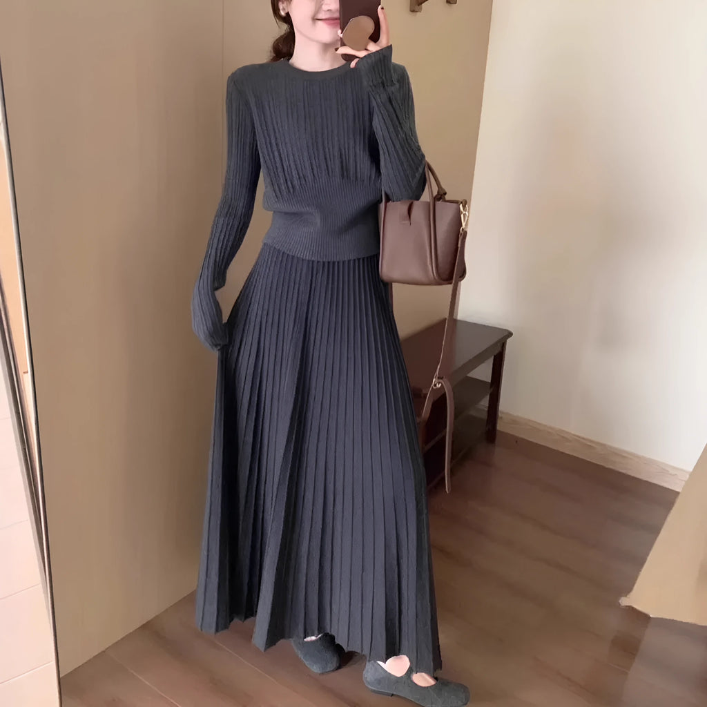 Women's dark grey knitted dress suit with 3D patterning and ethnic collage stitching, showing sweater and skirt two-piece set