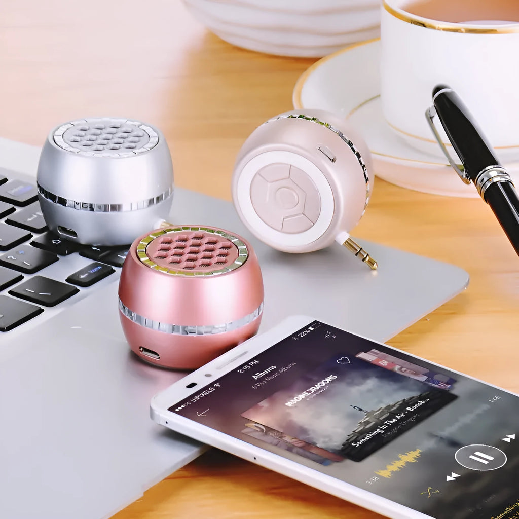 Universal external amplifier speaker in black, local gold, and rose gold finishes, showing wired input and USB power port.