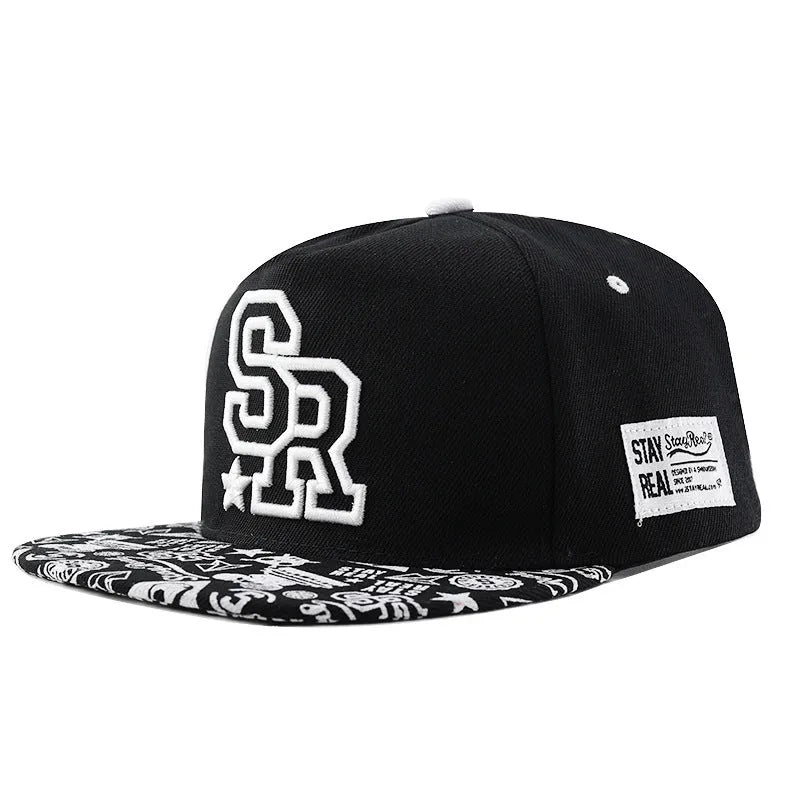 Black cotton baseball hat with white embroidered letters on the front, showing the dome crown shape.