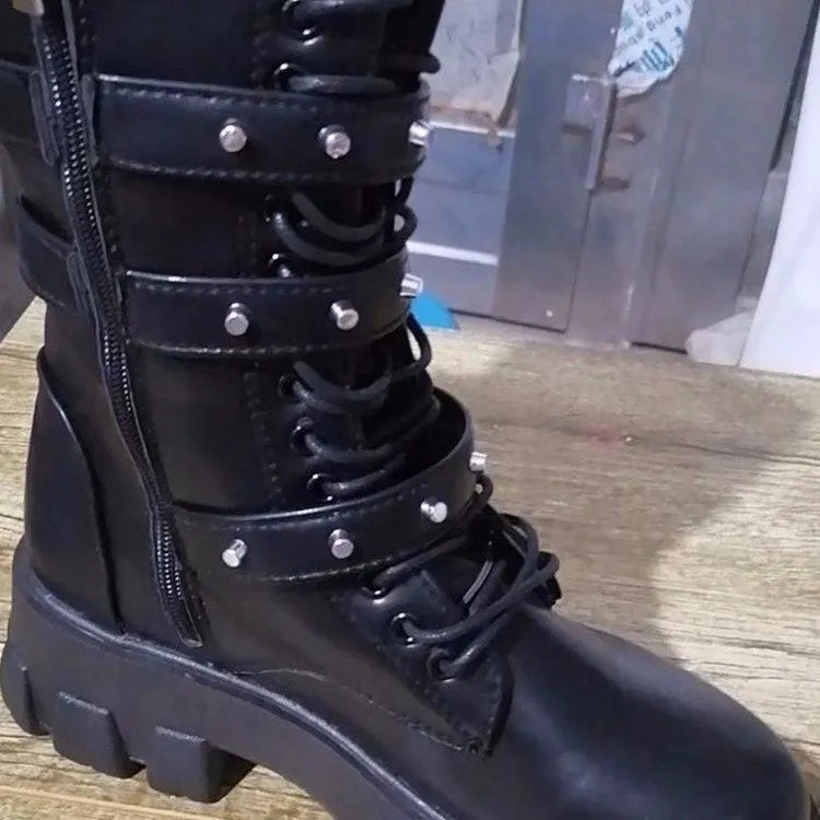 Women's black mid-calf knight boots with a metal buckle and side zipper on a chunky sole.