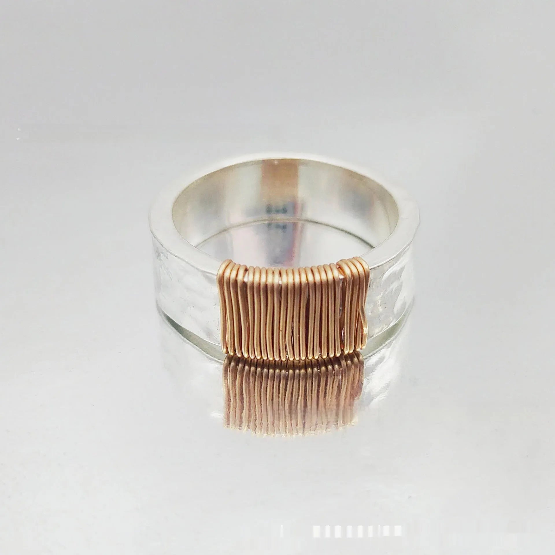 Copper geometric simple bracelet with silver gold coil finish and wide ring design.