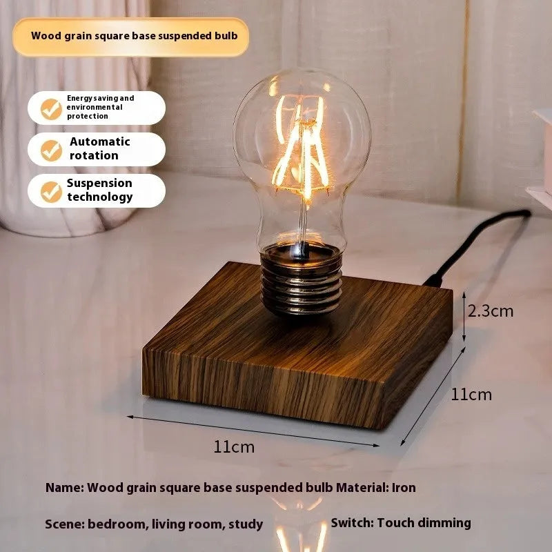 Creative iron art suspension bulb night lamp on a black wood grain desktop base.