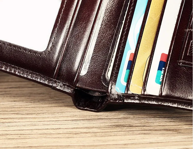 Men's leather wallet open showing photo window, card slots, coin pocket, and banknote compartment.