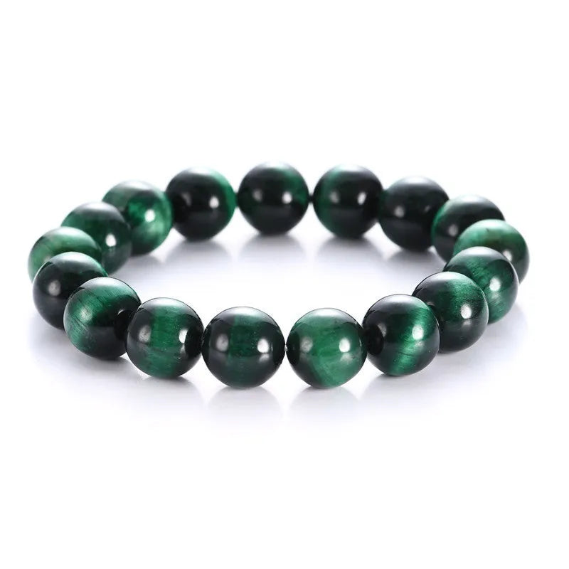 Polished green tiger eye stone beaded bracelet on a white background, showing geometric shaped beads.