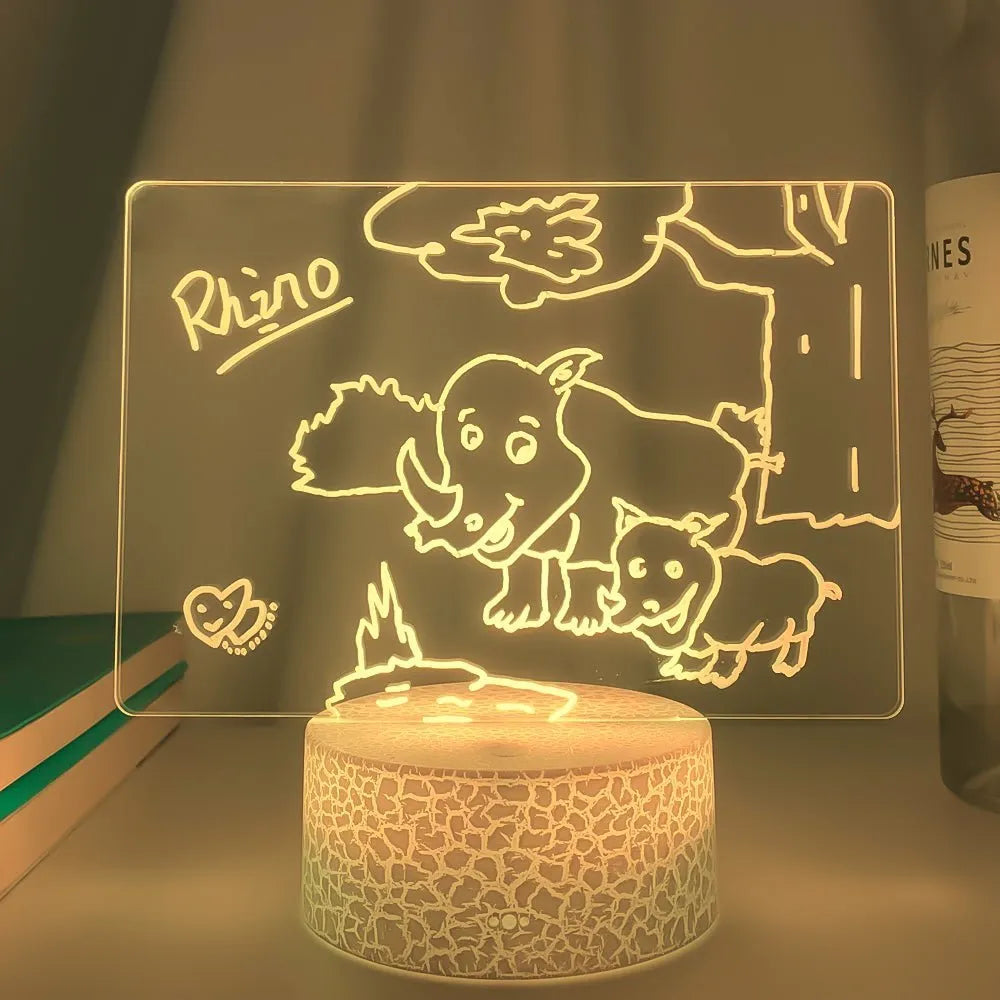 Black 3D acrylic message board night light with remote control and stylus on desk