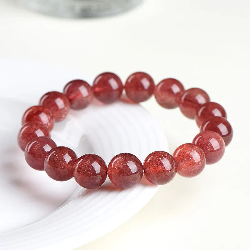Polished cherry red strawberry quartz geometric bracelet on a white background, showing 3A and 5A grade options.