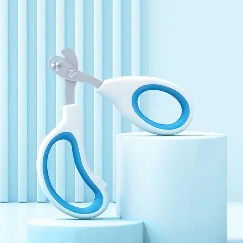 Blue cat nail clippers with circular hole and cushioned handle on a plain background
