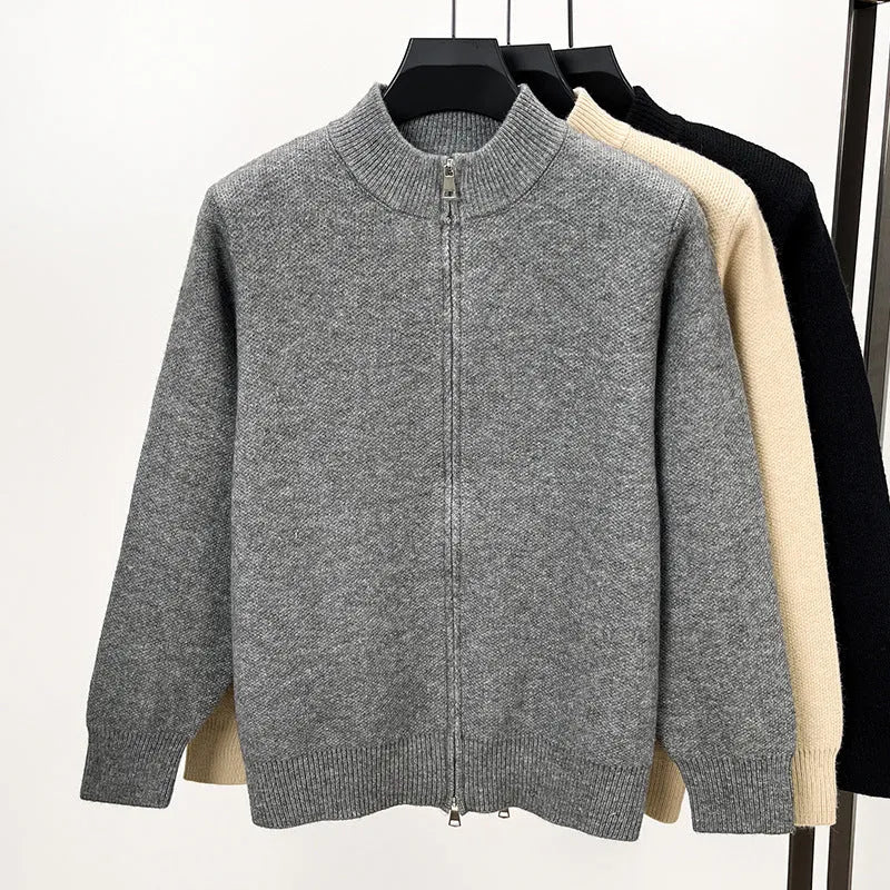 Man wearing a beige stand collar knitted zip cardigan in a loose fit.
