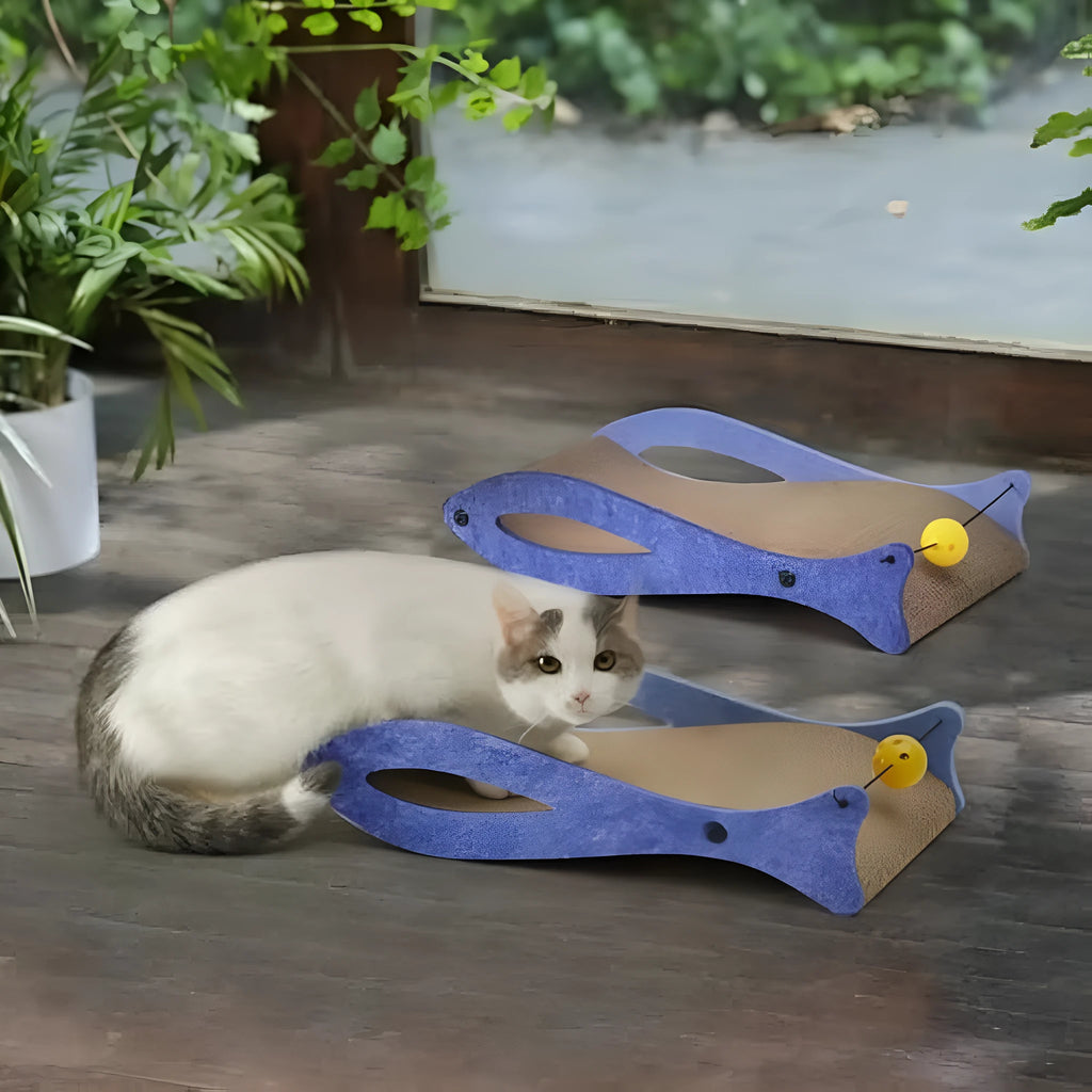 Blue fish-shaped corrugated cardboard cat scratcher lounge with a dangling bell ball toy.
