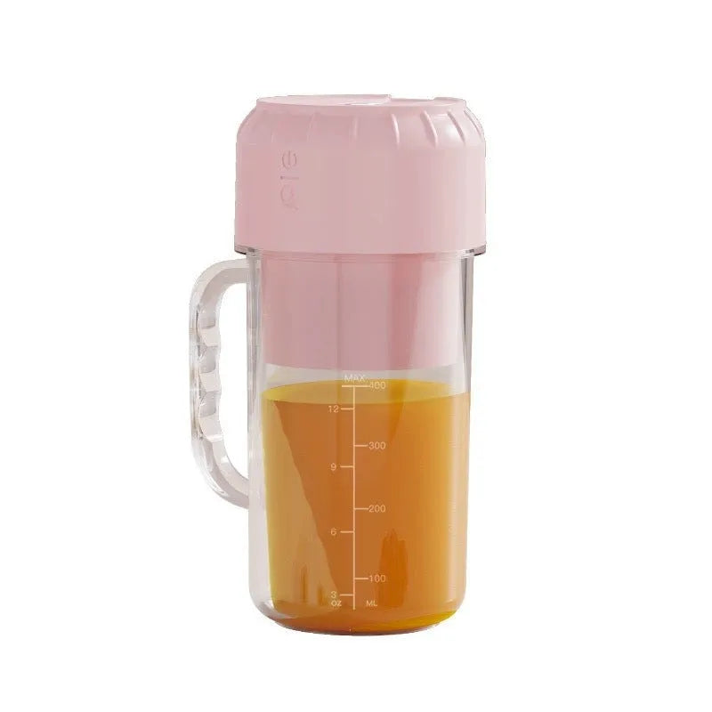 Portable USB mini juicer in avocado green or pink with multiple blade options on a countertop.