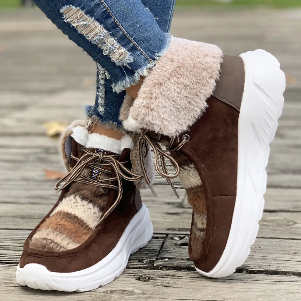 Beige women's lace-up mid-top snow boots with fuzzy lining and a thick rubber sole.