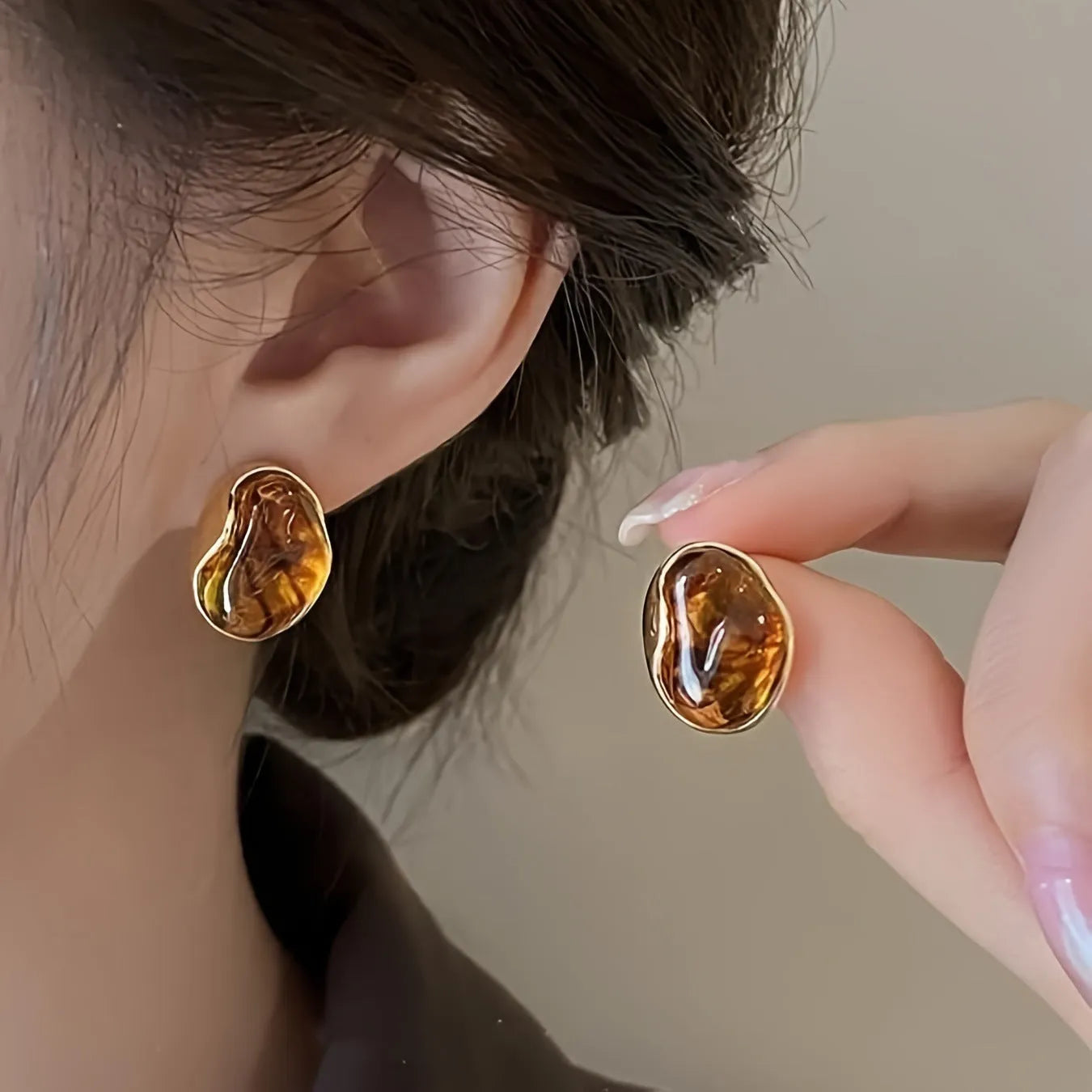 Three pairs of geometric alloy earrings with electroplated finishes in irregular amber, wafer round, and water drop tassel styles