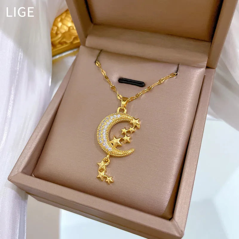 Moon pendant necklace with diamond accents and tassel on stainless steel chain