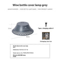 Beige wine bottle-shaped rechargeable camping lantern showing its size and USB-C port.
