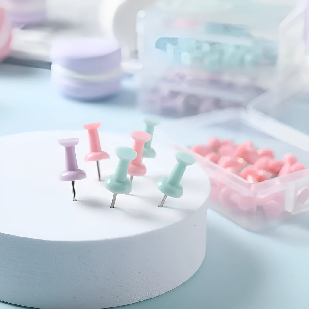 Assortment of plastic push pins in cherry blossom pink, mint green, and lavender, showing large and small sizes.