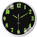 8 inch diameter modern wall clock with luminous hands on a wall.