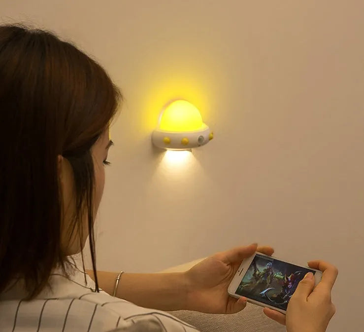 Remote control UFO-shaped bedside night light in blue, pink, or white with LED lighting
