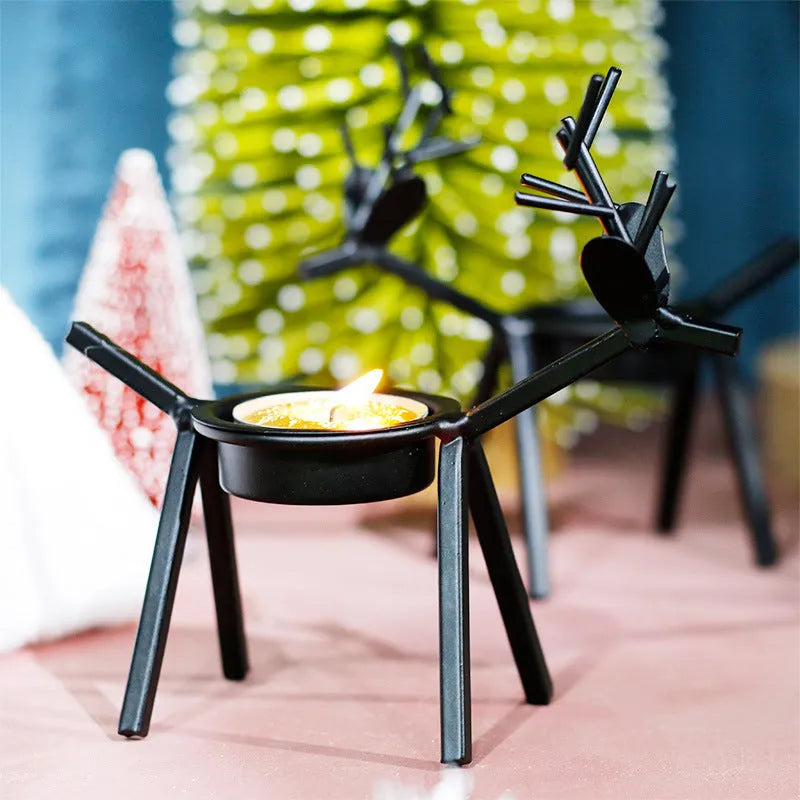 Black iron Christmas deer candlestick holder with elk bracket and festive motifs.