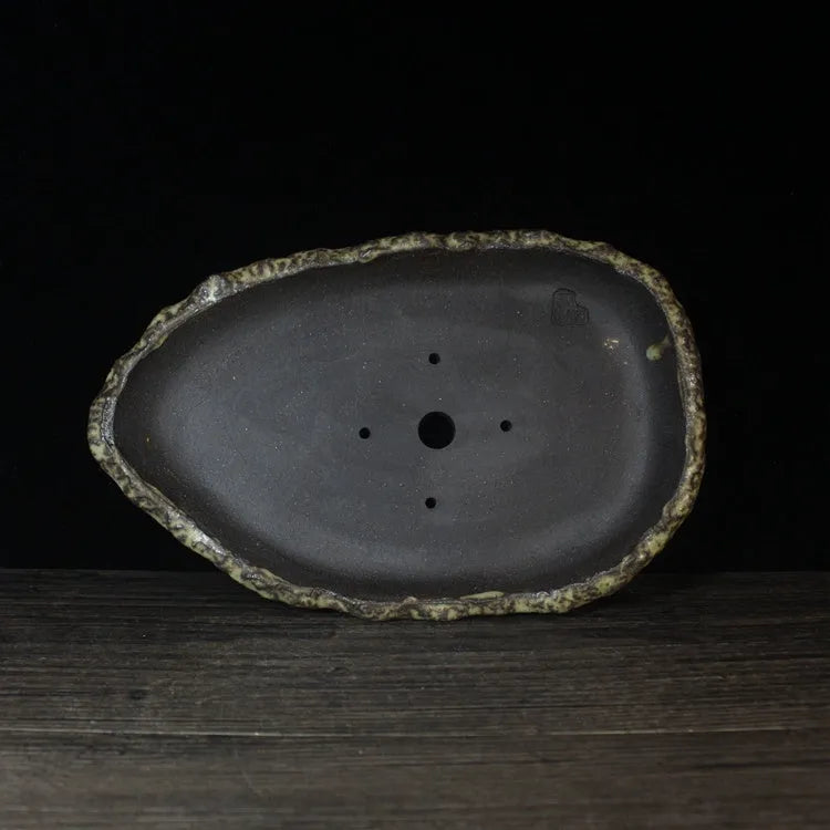 Handmade purple clay flower pot with traditional ceramic finish and drainage hole