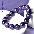 Transparent charoite crystal beaded bracelet with platinum-colour metal on a white background.