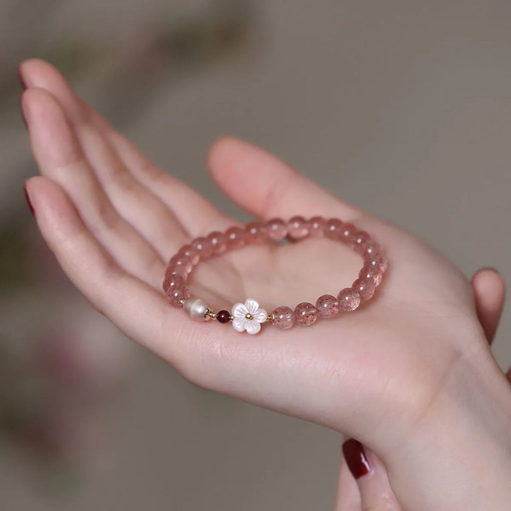 Strawberry quartz crystal flower bracelet with adjustable fastening on wrist