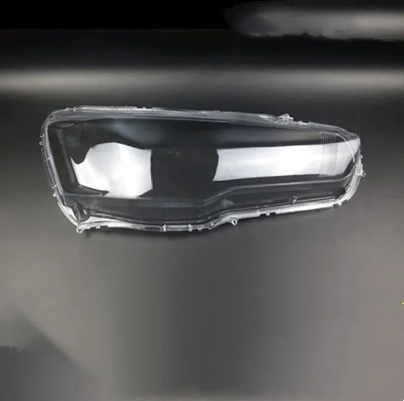 Clear plastic car headlight housing cover with dimensions 50mm by 30mm by 20mm.