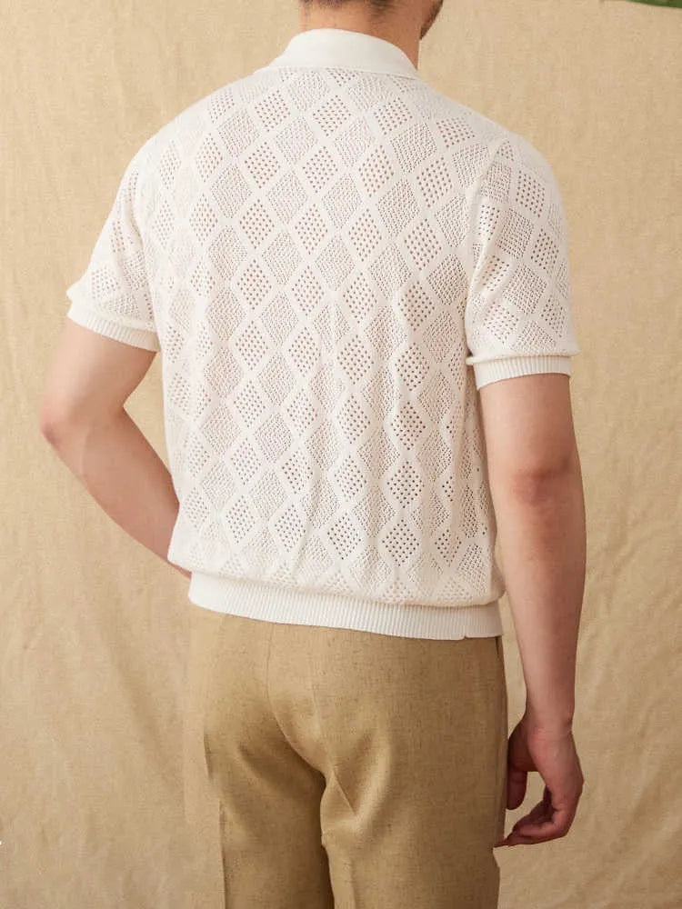 Men's light brown short sleeve cotton cardigan with zip front and lapel collar laid flat.