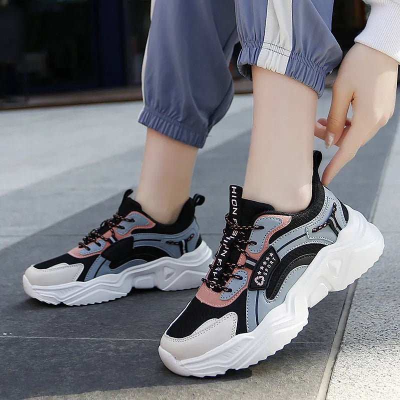 Women's white mesh casual sports shoes with a thick sole and a front buckle strap.