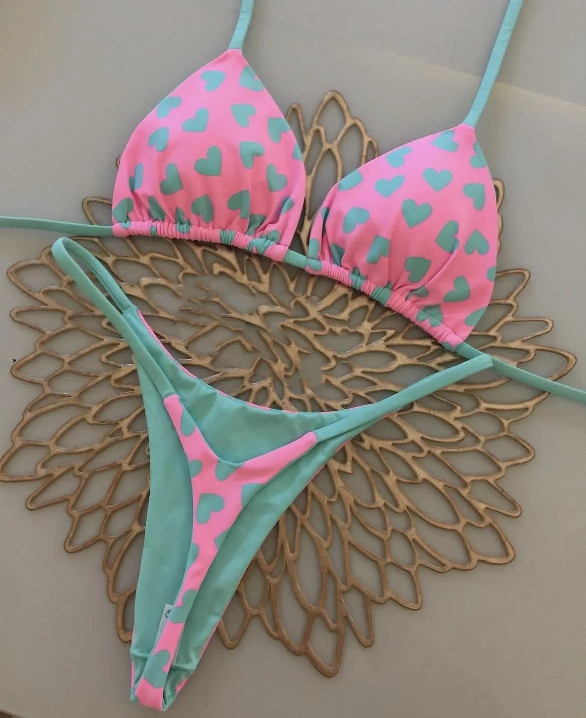 Heart print sexy backless split swimsuit bikini in a briefs style on a mannequin.