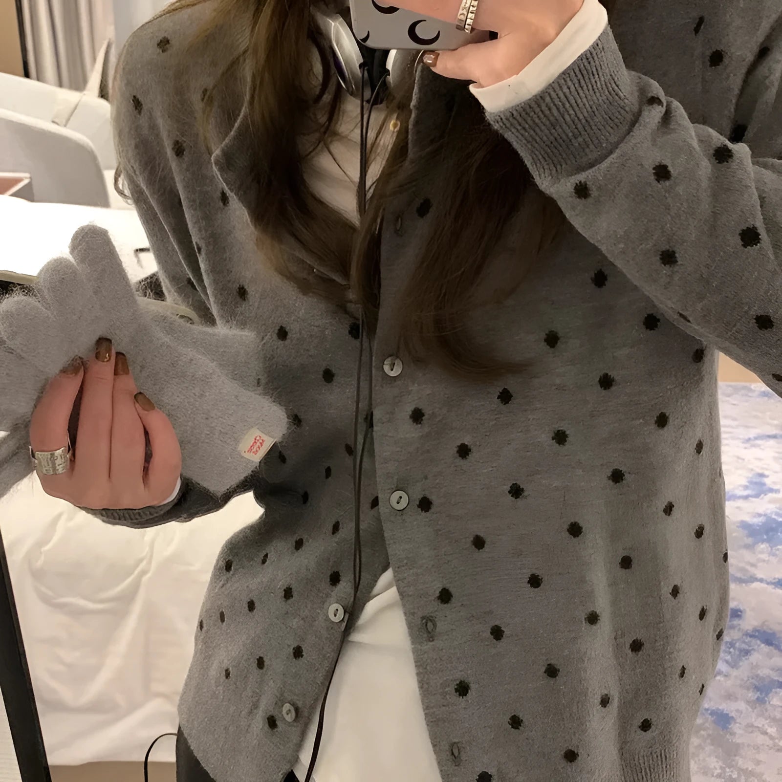 Women's grey dot knitted cardigan with crocheted flower detail and long sleeves