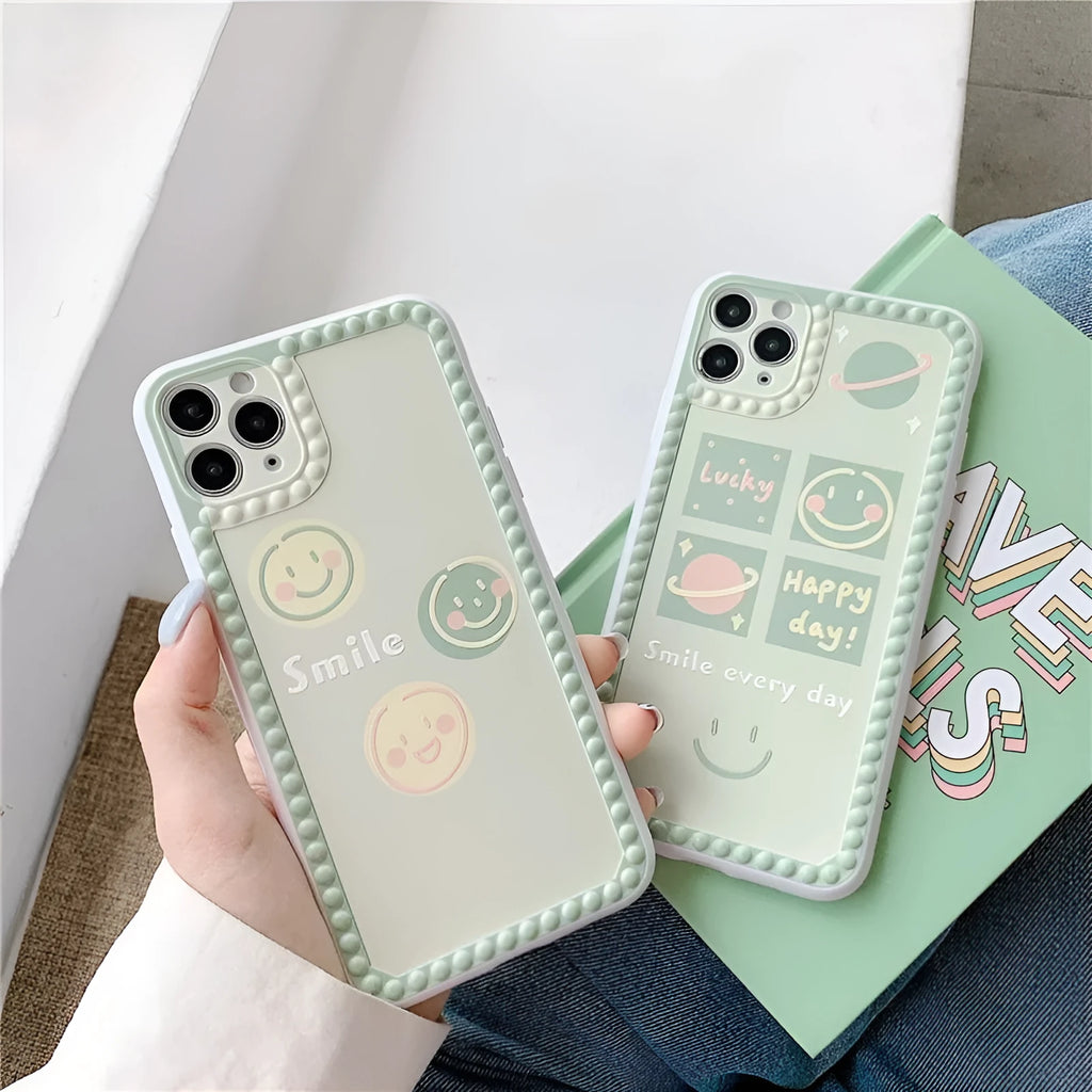 Green TPU iPhone case with geometric smiley face polka dot patterns on a phone