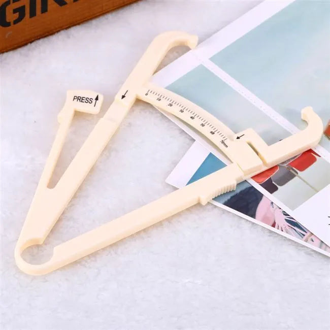 Acrylic body fat caliper measuring tool showing compact design and measurement scale