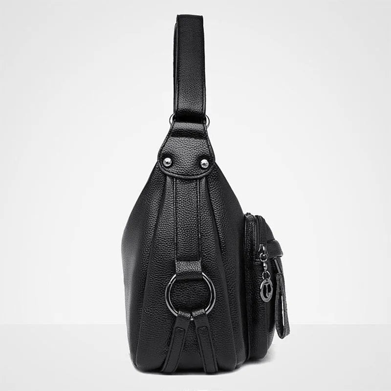 Large black women's shoulder bag with multiple compartments and luggage-inspired styling