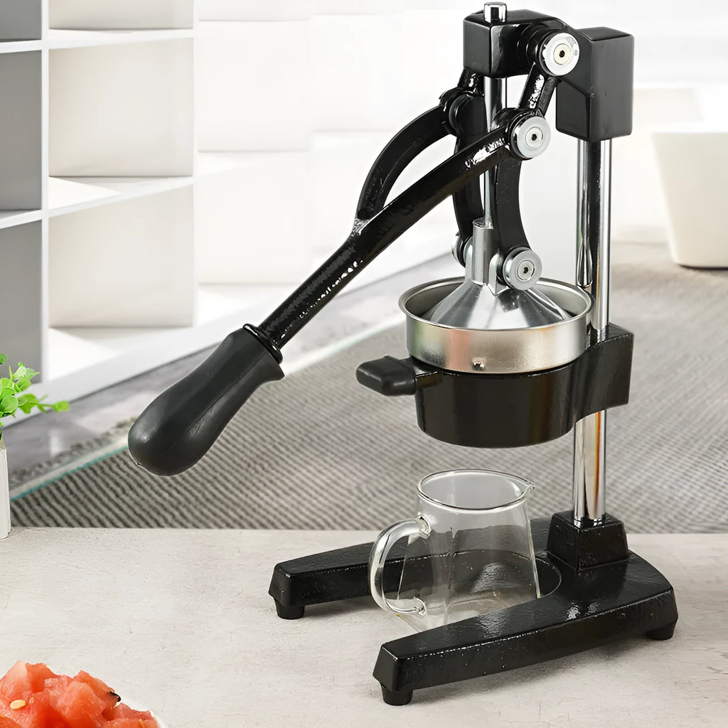 Black and white manual citrus juicer with cast iron base and stainless steel funnel