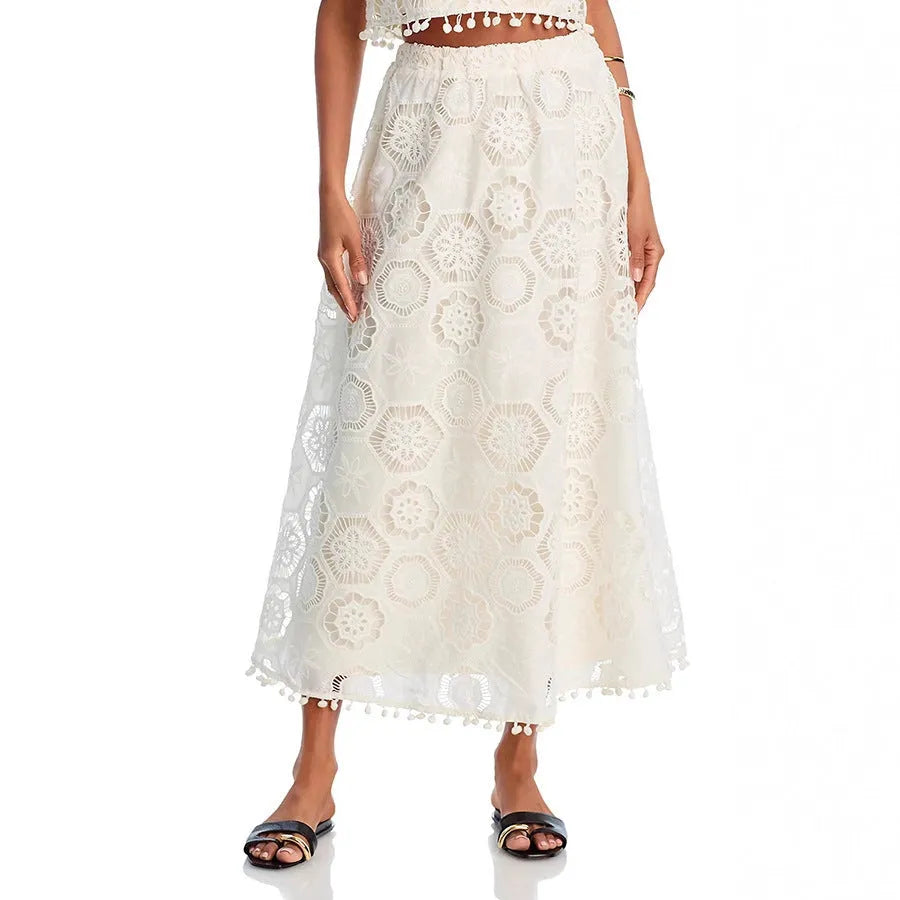 White women's sleeveless top and long skirt suit set with embroidery detailing