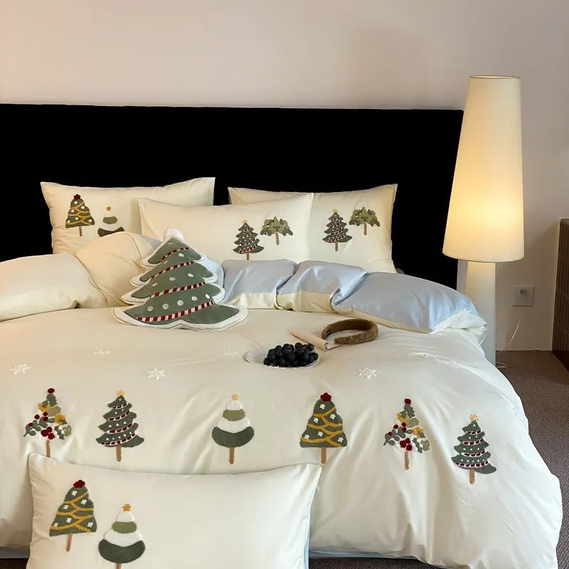 Cream blue embroidered Christmas tree and flowers on a cotton duvet cover with matching pillowcases