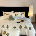 Cream blue embroidered Christmas tree and flowers on a cotton duvet cover with matching pillowcases