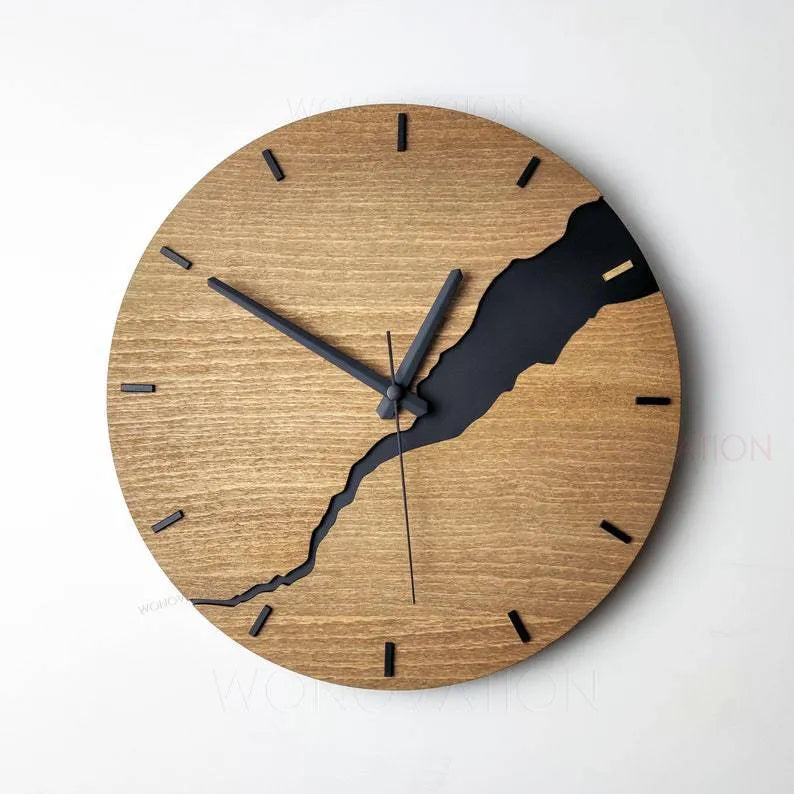 Modern round wooden wall clock with crackle design, white face, and black hands.