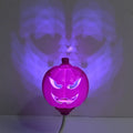 Plastic pumpkin-shaped decorative lamp with purple or yellow light, standing 22cm tall.