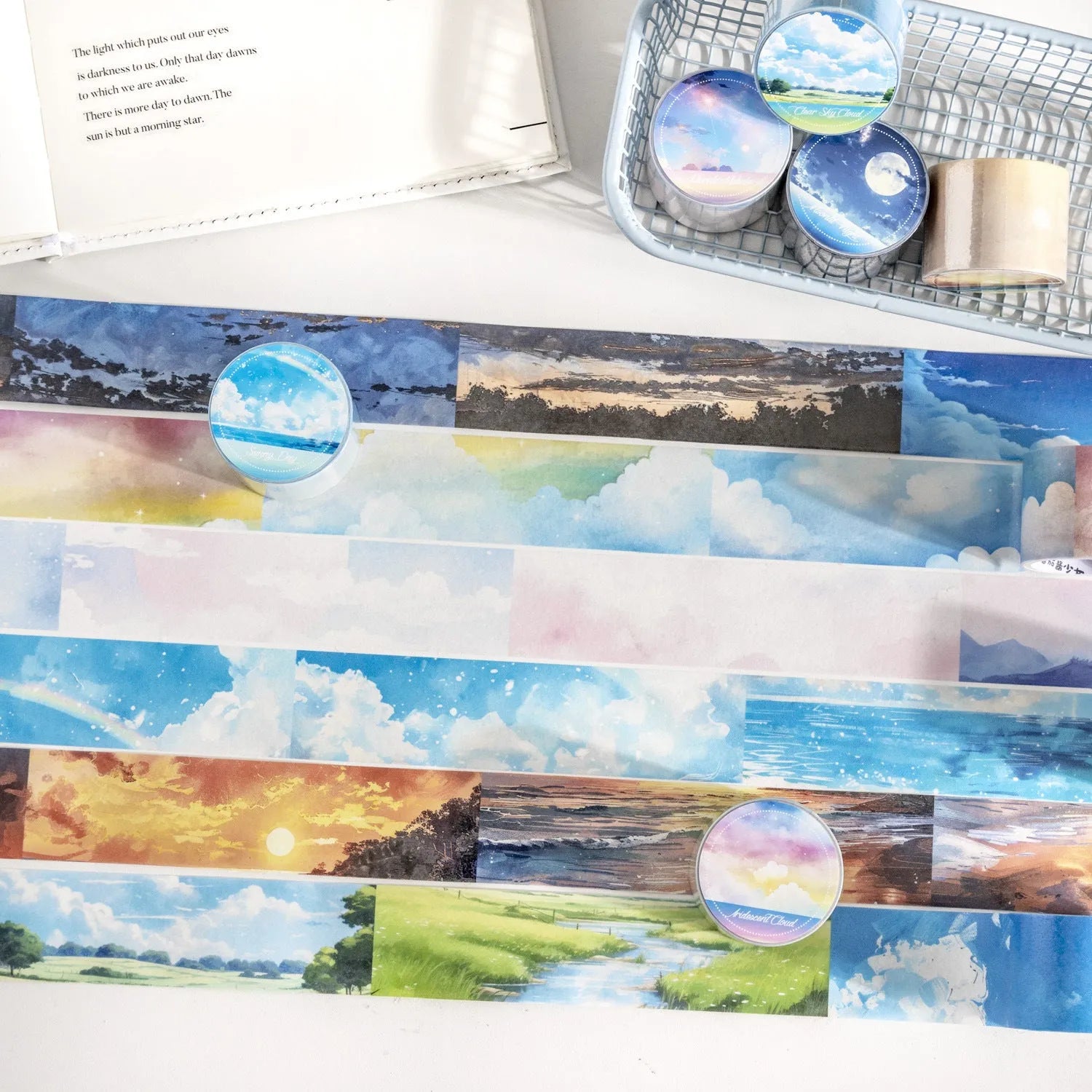 Roll of Japanese paper decorative tape with sky theme patterns including clouds, sun, moon, and nebula.